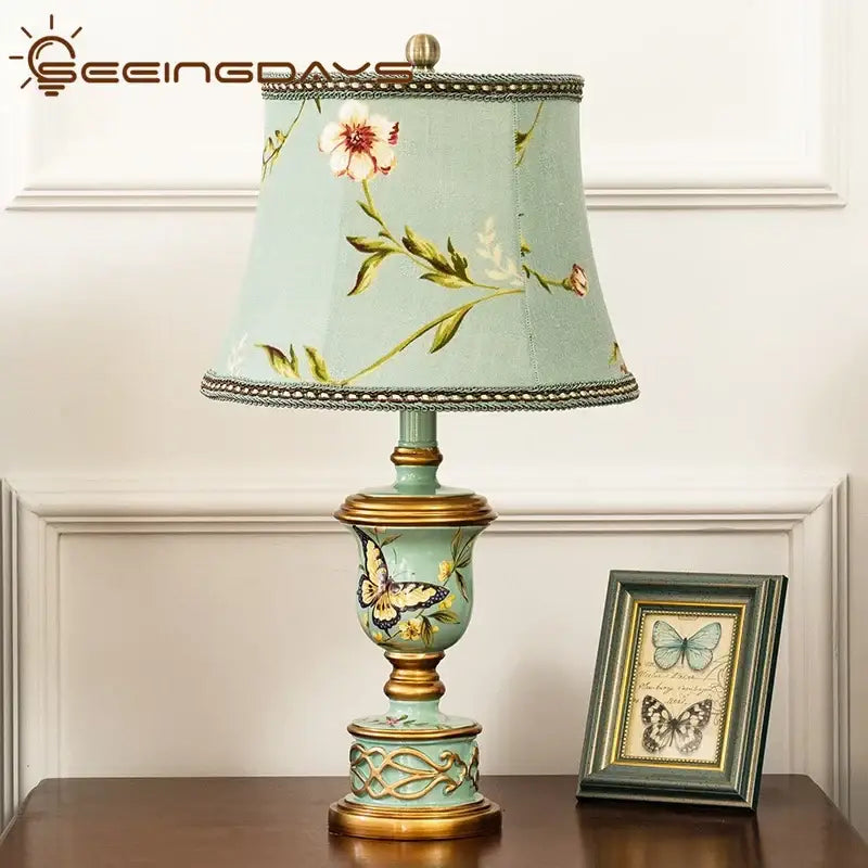 Retro mint green resin table lamp with butterfly detail bedroom light