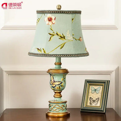 Retro mint green resin table lamp with butterfly detail bedroom light