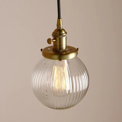 Ribbed glass globe pendant light with brass fixture for living room