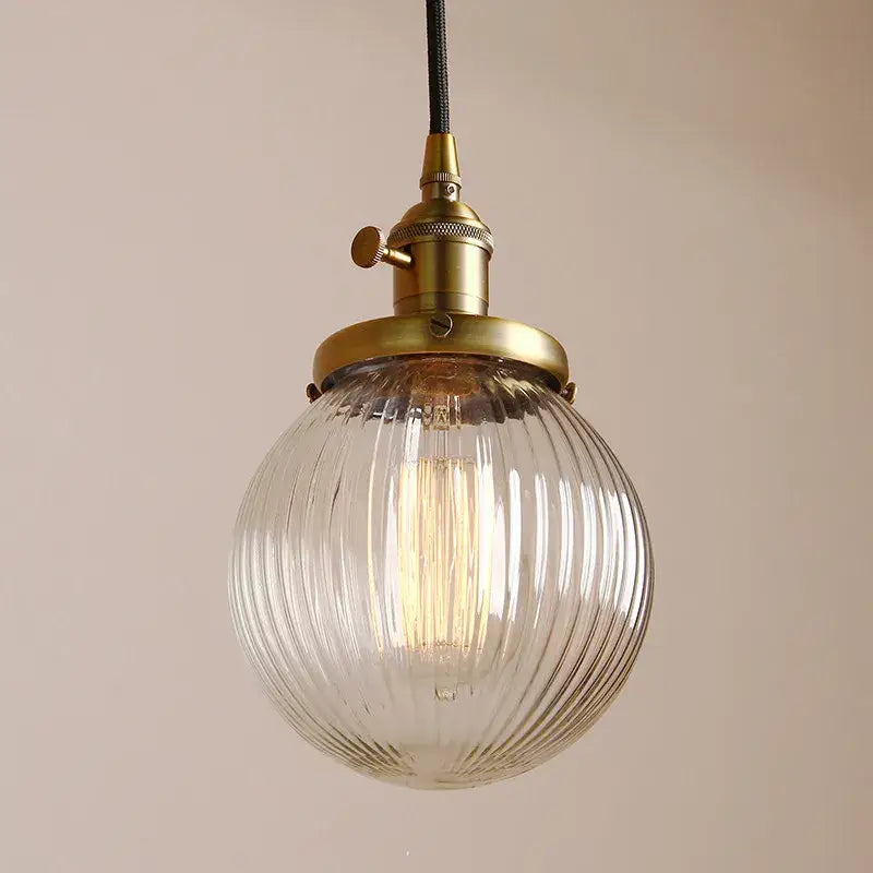 Ribbed glass globe pendant light with brass fixture for living room
