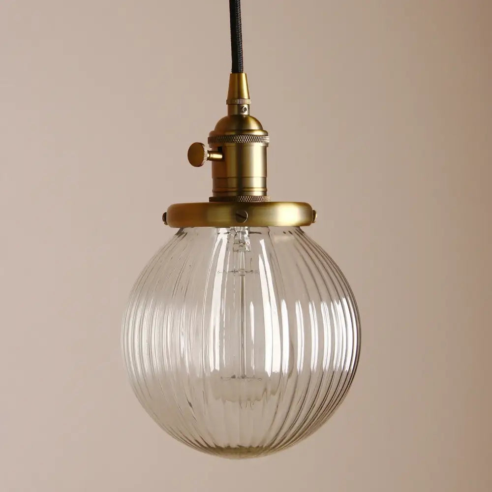 Ribbed glass globe pendant light with brass fixture for living room
