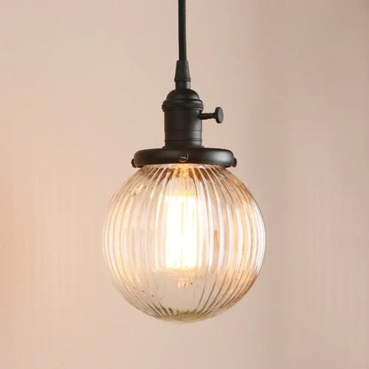 Ribbed glass globe pendant light with brass fixture for living room
