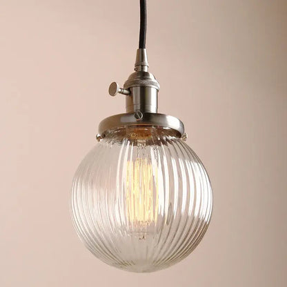 Ribbed glass globe pendant light with brass fixture for living room