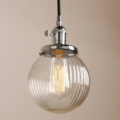 Ribbed glass globe pendant light with brass fixture for living room