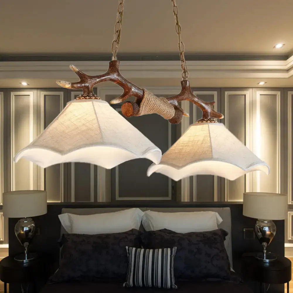 Rustic brown antler ceiling light with flaxen fabric shades bedroom