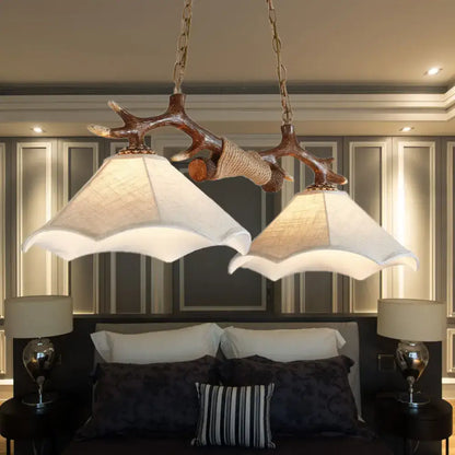 Rustic brown antler ceiling light with flaxen fabric shades bedroom