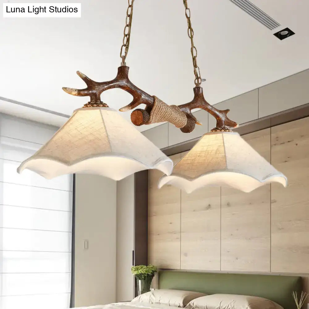 Rustic brown antler ceiling light with flaxen fabric shades bedroom