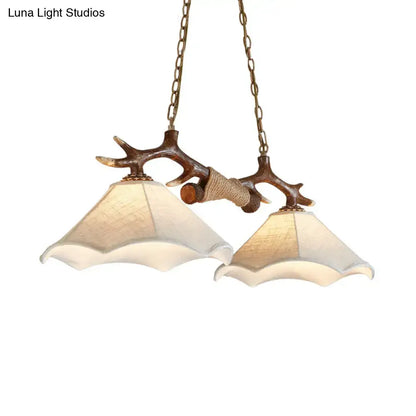 Rustic brown antler ceiling light with flaxen fabric shades bedroom
