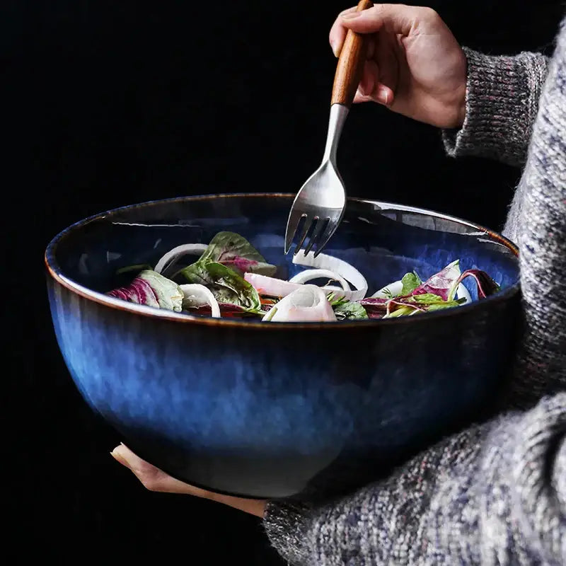 Rustic deep blue ceramic salad bowl with wooden fork dining room