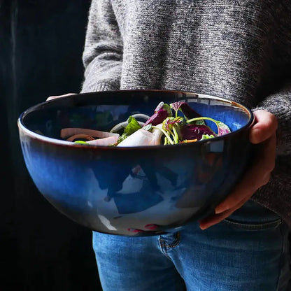 Rustic deep blue ceramic salad bowl with wooden fork dining room