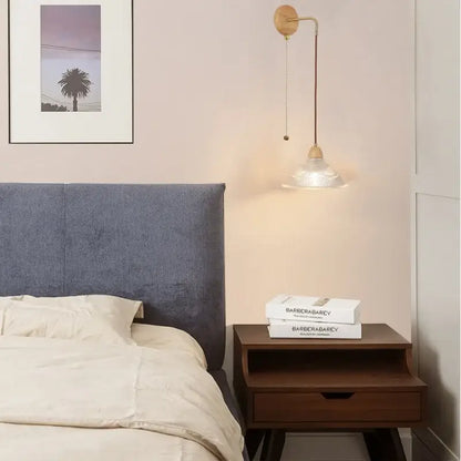 Rustic wood and brass wall light with clear glass pull chain switch