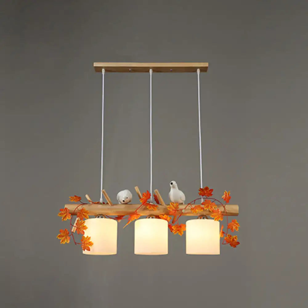 Rustic wood island light with maple leaf plant birds dining room