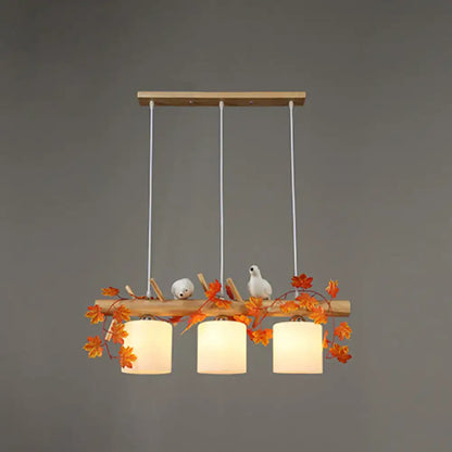Rustic wood island light with maple leaf plant birds dining room
