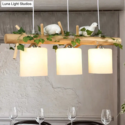 Rustic wood island light with maple leaf plant birds dining room