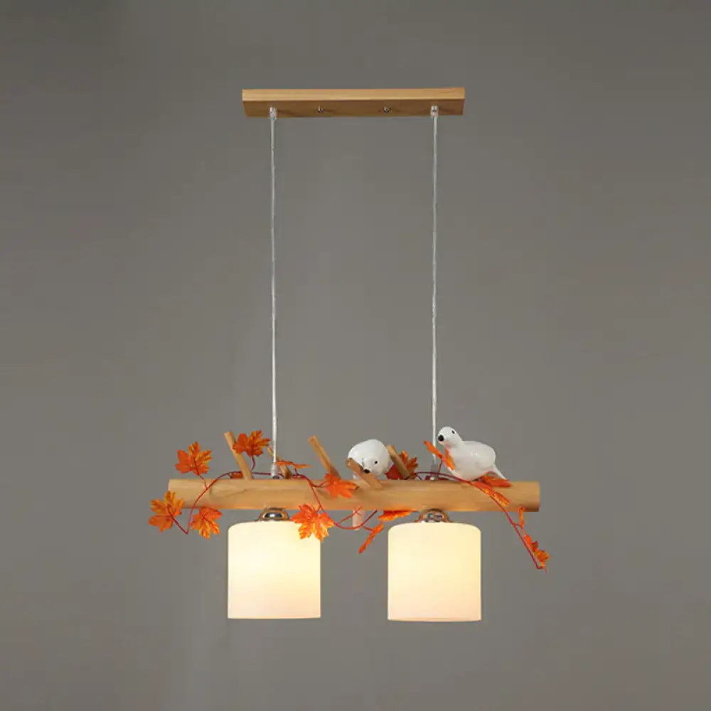 Rustic wood island light with maple leaf plant birds dining room