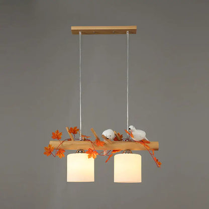 Rustic wood island light with maple leaf plant birds dining room