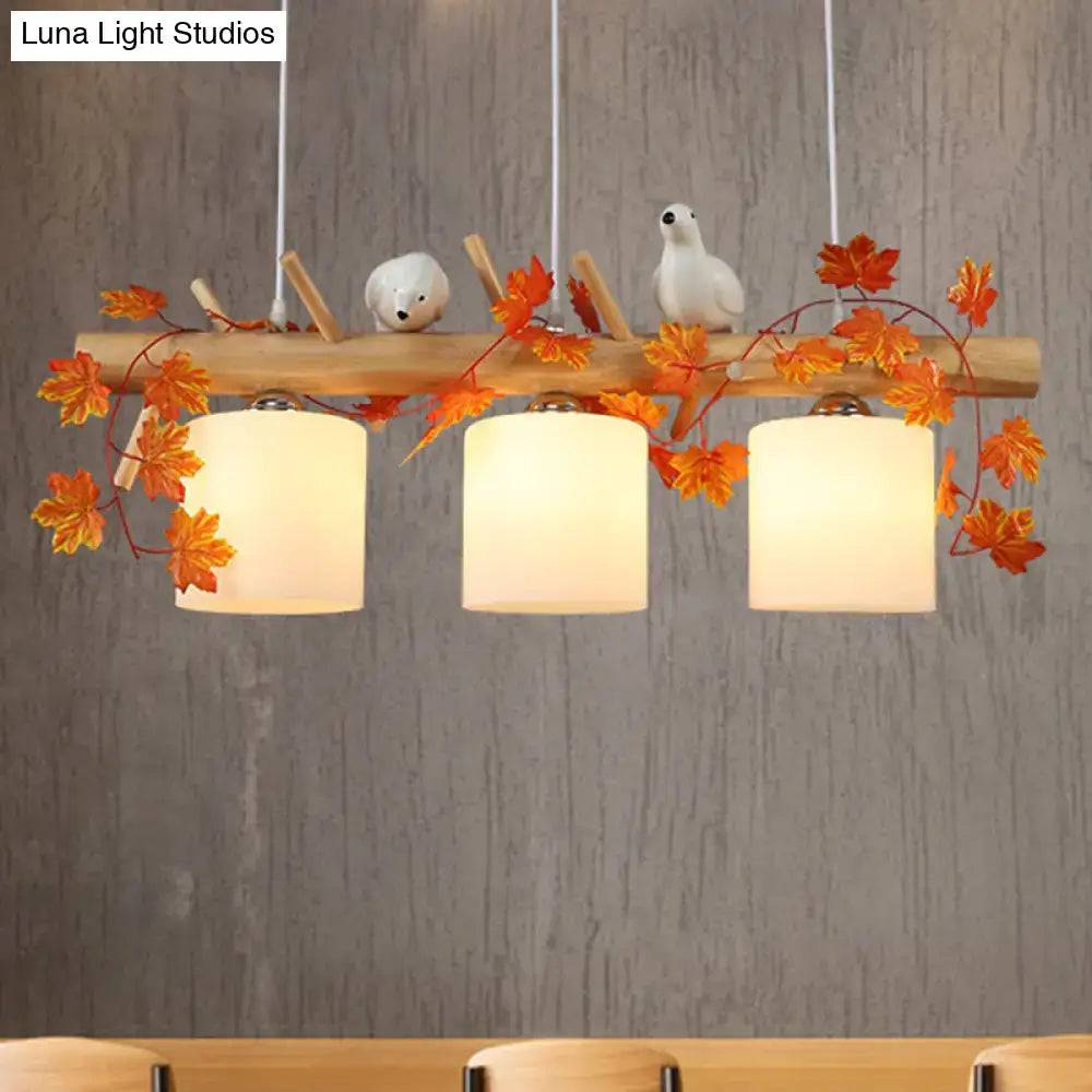 Rustic wood island light with maple leaf plant birds dining room