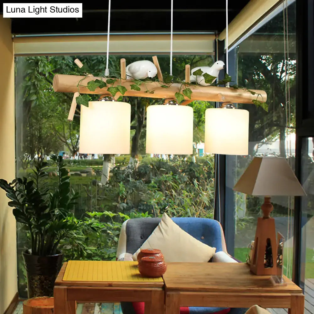 Rustic wood island light with maple leaf plant birds dining room