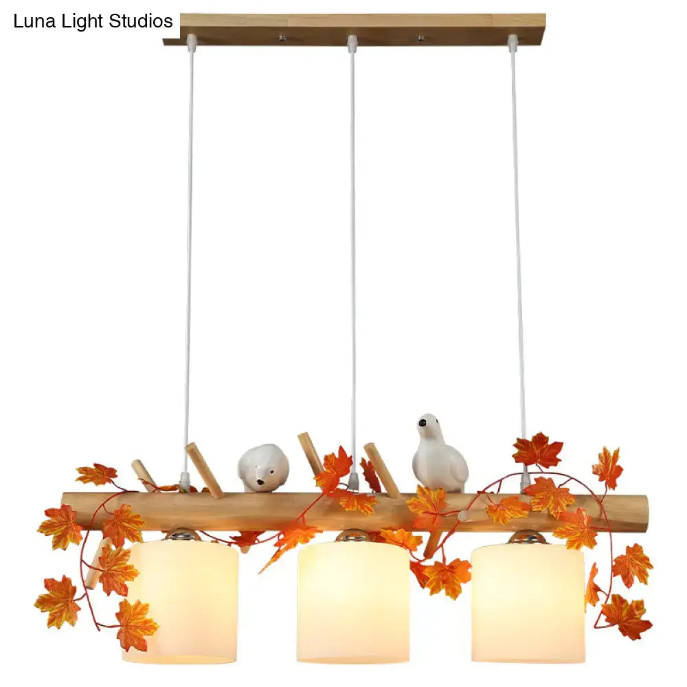 Rustic wood island light with maple leaf plant birds dining room