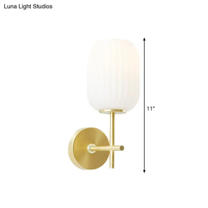 Simple gold light fixture with cream glass shade bedroom wall sconce