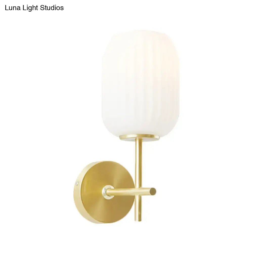 Simple gold light fixture with cream glass shade bedroom wall sconce