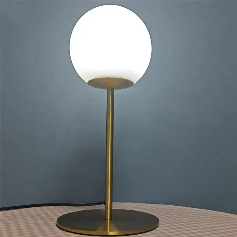 Sleek brass glass ball table lamp for bedroom with frosted shade