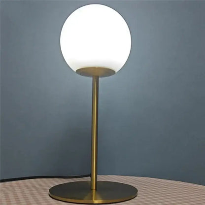 Sleek brass glass ball table lamp for bedroom with frosted shade