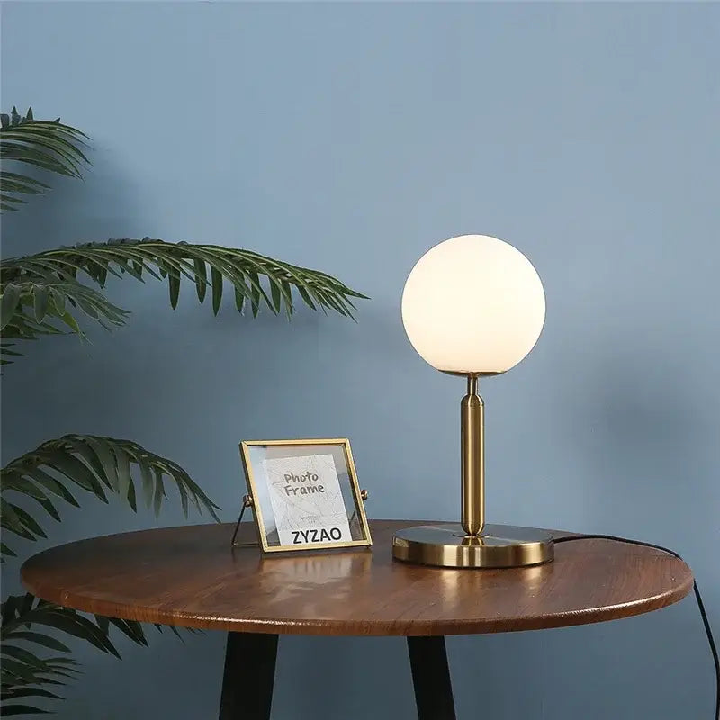 Sleek brass glass ball table lamp for bedroom with frosted shade