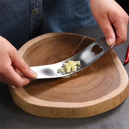 Sleek stainless steel garlic press with integrated spoon kitchen tool