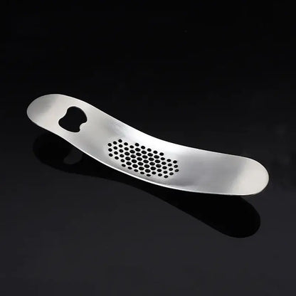 Sleek stainless steel garlic press with integrated spoon kitchen tool