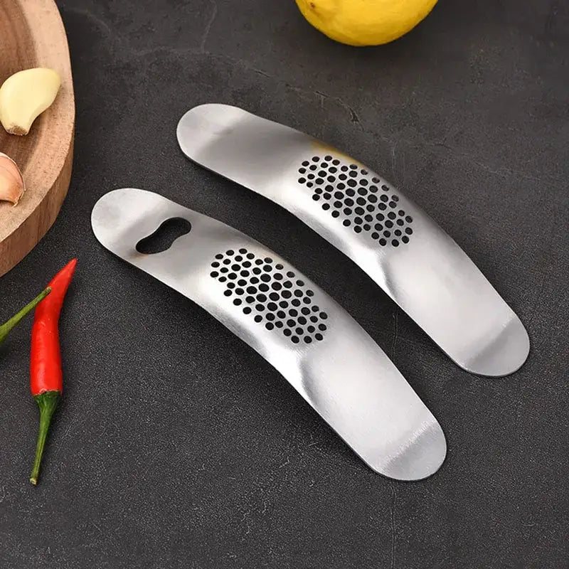 Sleek stainless steel garlic press with integrated spoon kitchen tool