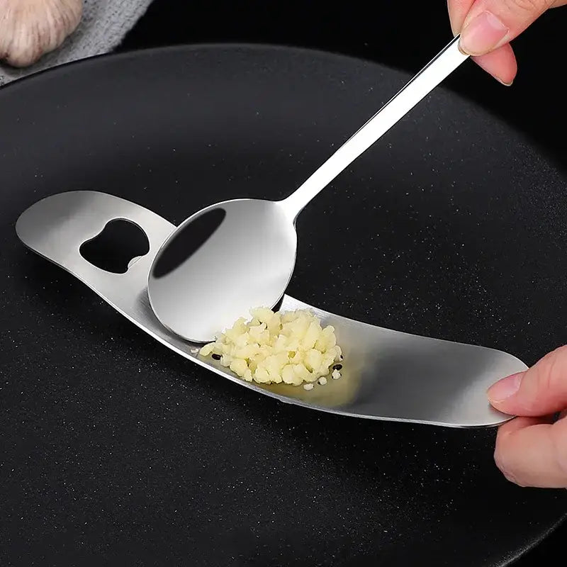 Sleek stainless steel garlic press with integrated spoon kitchen tool