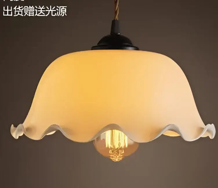 Teal blue glass pendant light with brass hardware for dining room