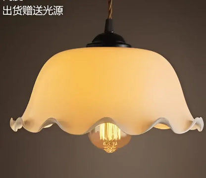 Teal blue glass pendant light with brass hardware for dining room