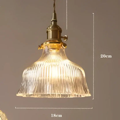 Teal blue glass pendant light with brass hardware for dining room