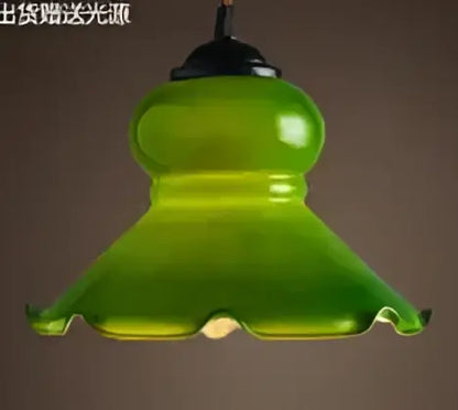 Teal blue glass pendant light with brass hardware for dining room