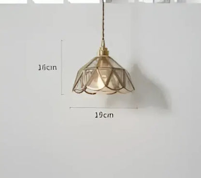 Teal blue glass pendant light with brass hardware for dining room