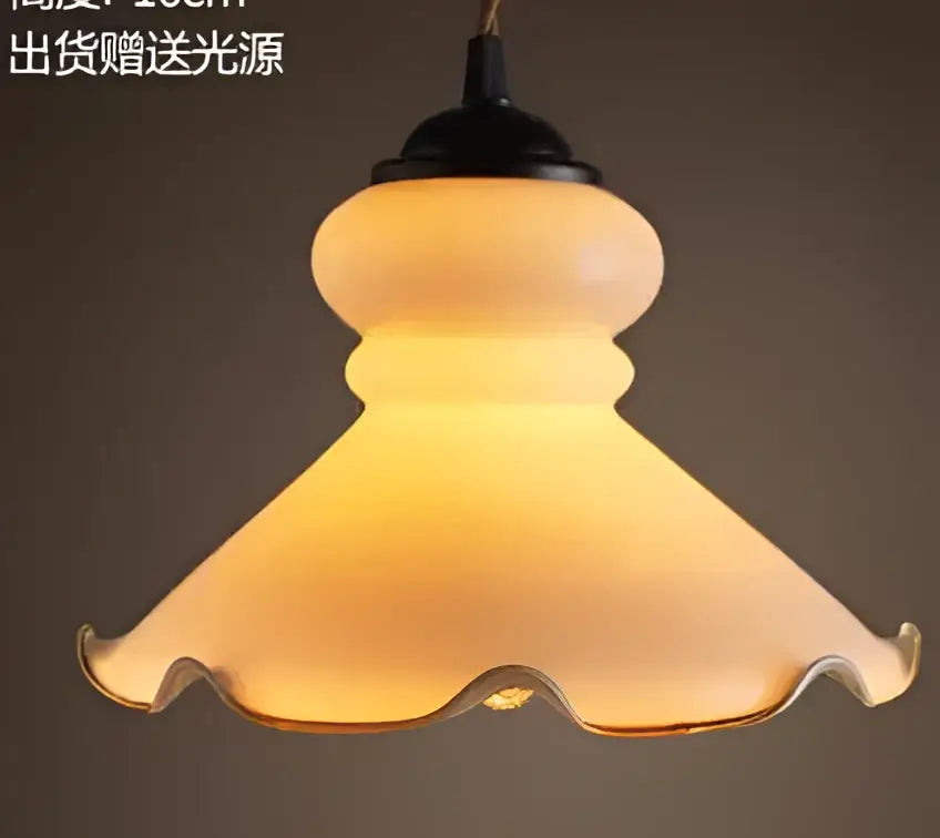 Teal blue glass pendant light with brass hardware for dining room