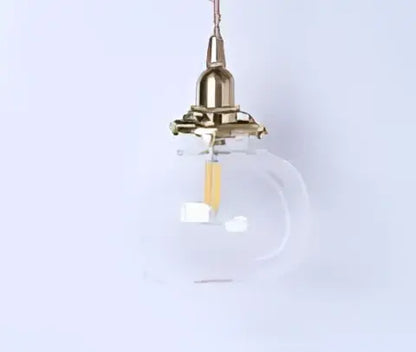 Teal blue glass pendant light with brass hardware for dining room