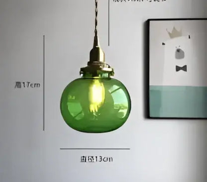 Teal blue glass pendant light with brass hardware for dining room