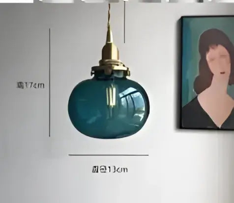Teal blue glass pendant light with brass hardware for dining room