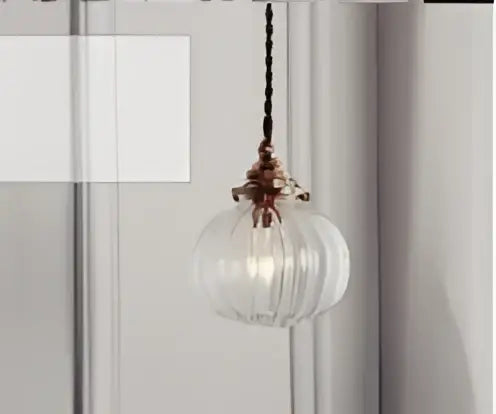 Teal blue glass pendant light with brass hardware for dining room