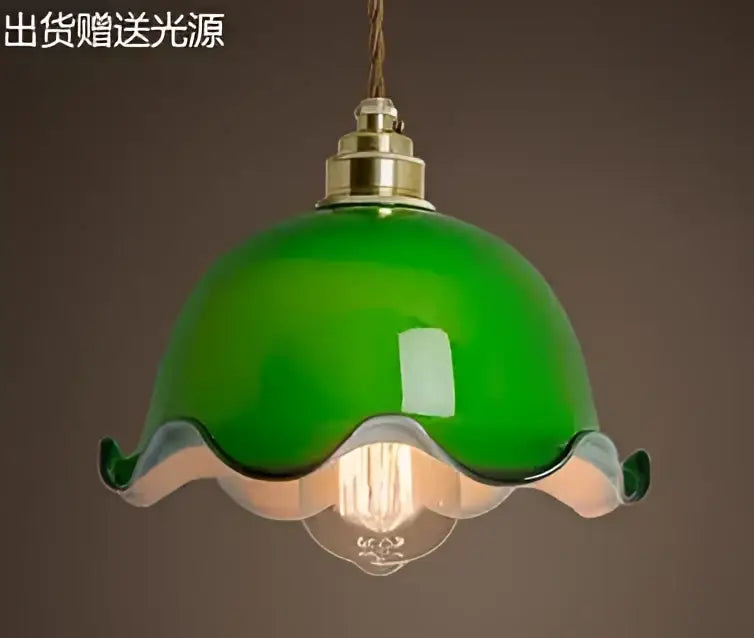 Teal blue glass pendant light with brass hardware for dining room