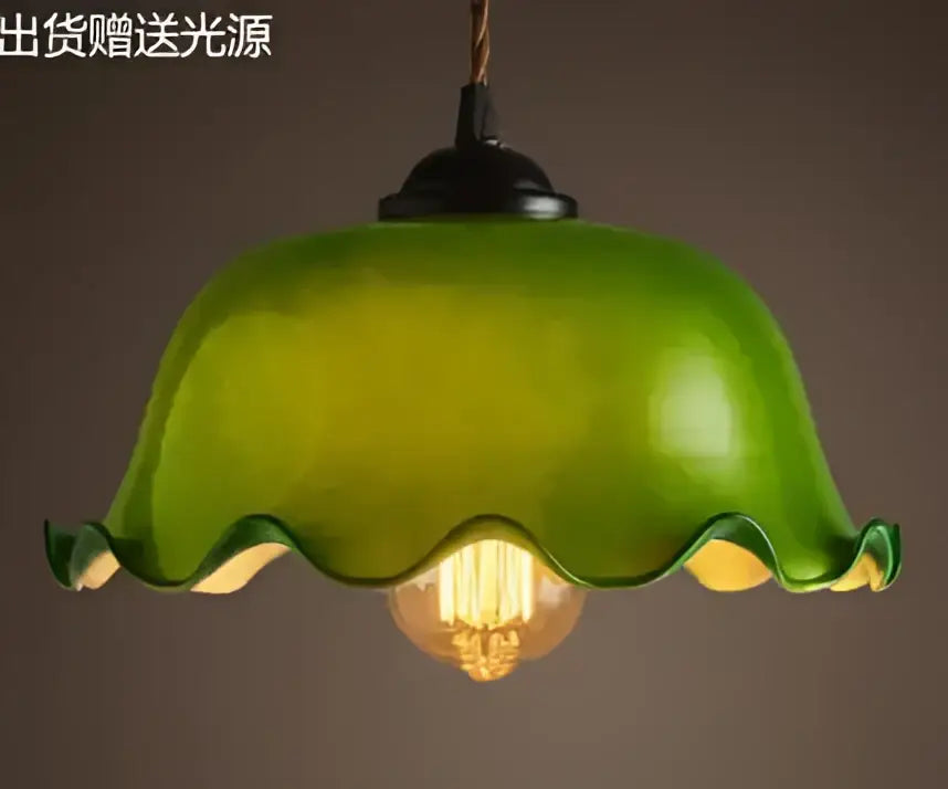 Teal blue glass pendant light with brass hardware for dining room
