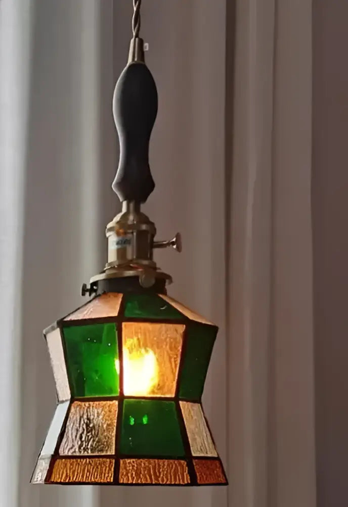 Teal blue glass pendant light with brass hardware for dining room