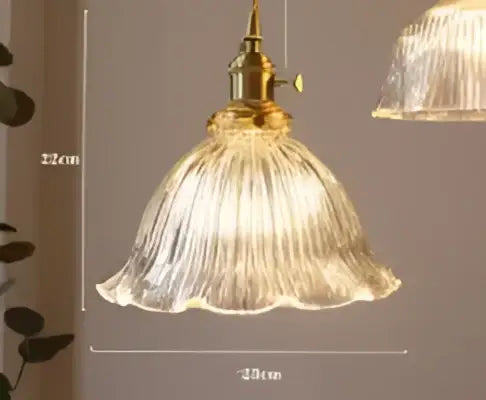Teal blue glass pendant light with brass hardware for dining room