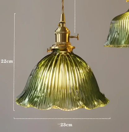Teal blue glass pendant light with brass hardware for dining room