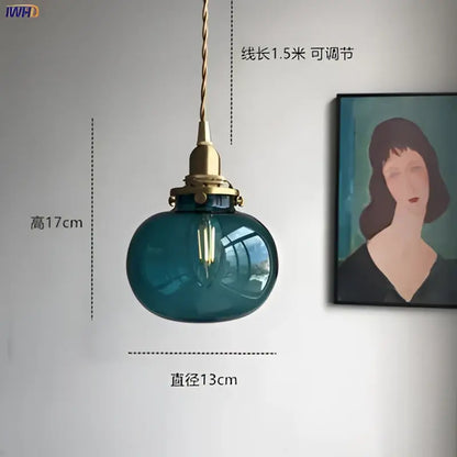 Teal glass ball pendant light with brass hardware for bedroom
