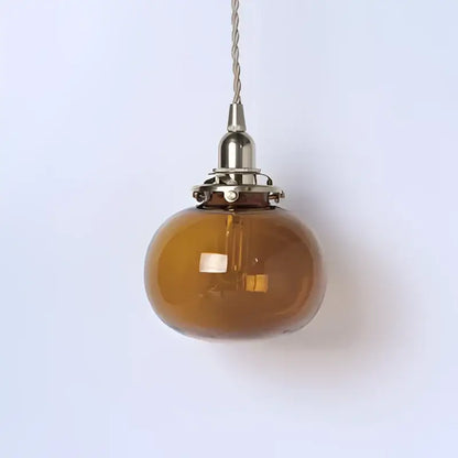 Teal glass ball pendant light with brass hardware for bedroom