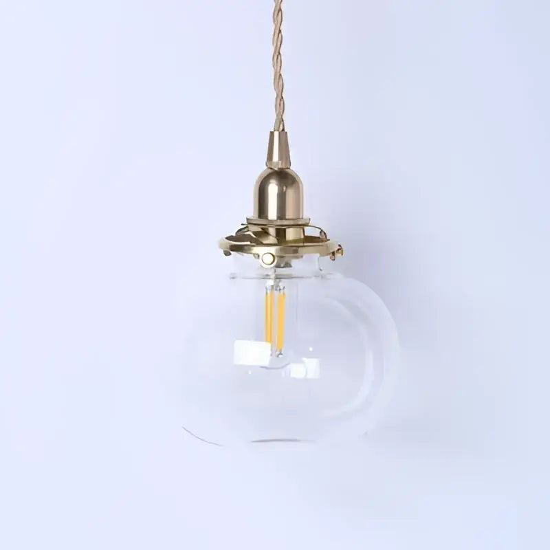 Teal glass ball pendant light with brass hardware for bedroom